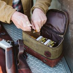 Out in the field, where every second counts, being prepared is key. Our Dakota shell bag is your reliable companion for any shooting adventure. Whether you’re at a trap shoot or on a hunt, this bag keeps your gear within arm’s reach. Made from water-resistant waxed canvas with a durable leather bottom and handle, it’s built to last as long as your gun. With capacity for up to 125 loose shells or five 25-count boxes, it’s the perfect size for your shooting needs. The wipeable nylon interior makes Gifts For Outdoorsmen, Shooting Rest, Buffalo Jackson, Shooting Bags, Trap Shooting, Shell Bag, Hunting Bags, Shotgun Shell, Sand Bag