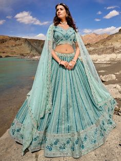 Introducing the bewitching sky-blue mirror work georgette wedding lehenga choli from Ethnic Plus! This exquisite ensemble is designed to make you look and feel like a true princess on your special occasions. Made with sky-blue color georgette material, this lehenga features stunning sequin work and mirror work, adding a touch of sparkle and glamour to your overall look.
The set includes a matching choli made with similar color georgette material, also adorned with sequin work and mirror work, cr Embroidered Skirts, Girls Lehenga, Heavy Lehenga, Engagement Lehenga, Designer Bridal Lehenga Choli, Sabyasachi Lehenga, Georgette Lehenga, Designer Bridal Lehenga, Kids Lehenga