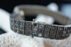 "This is the perfect option for those who like cool, unique jewelry and the luxury, shine of sterling silver . This bracelet is well made, cute and/or elegant in design, and very desirable. The bracelet is decorated with gray and clear cz . The clasp is in good working condition. The clasp is with safety hook. This bracelet is hard to find. The Wachenheimer Brothers Company of Providence, Rhode Island, started business in 1907. The bracelet is marked on the back of the catch Sterling Diamonbar P Luxury Silver Bracelets With Single Cut Diamonds, Silver Bracelets With 17 Jewels For Anniversary, Sterling Silver Bracelet With 17 Jewels For Gift, Art Deco Silver Jewelry With Hand Set Details, Art Deco Silver Jewelry With Diamond Accents, Art Deco Silver Jewelry With Hand Set, Art Deco Hand-set Silver Jewelry, Antique Hand Set Silver Jewelry, Art Deco Silver Diamond Bracelet As A Gift