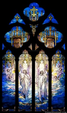 a stained glass window with angels in it