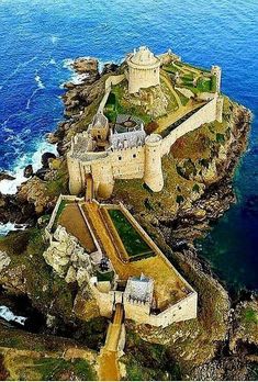 an aerial view of a castle on the coast