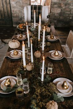 a table with candles and plates on it