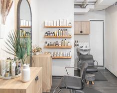 a hair salon with chairs and shelves filled with products