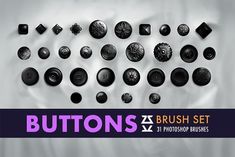 a bunch of buttons sitting on top of a white table next to a purple and black banner