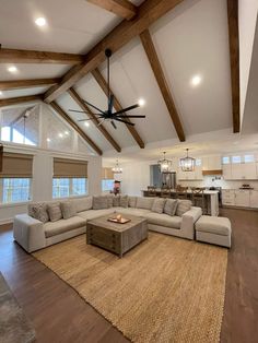 a living room filled with furniture and a ceiling fan in the middle of the room