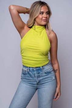 Elevate your summer wardrobe with our Citrus Halter Top. Featuring a high halter neck with button closure, mesh overlay, and side ruching, this top is both stylish and comfortable. The vibrant colors, lime and orange, will make you stand out at any event. 95% Polyester 5% Spandex Hand wash cold Import Fit guide: Isabella is 5ft 6 inches; Bust 34”, Waist 26”, Hips 35” Model is wearing a small True to size *Available at our Envy location Green Stretch Halter Neck Top, Green Halter Neck Tank Top For Night Out, Spring Stretch Lime Green Top, High Neck Tank Top For Night Out In Summer, High Neck Tank Top For Summer Nights, High Neck Tank Top For Summer Nights Out, Green Stretch High Neck Top, Yellow Stretch Halter Neck Top, Versatile High Neck Tank Top For Spring