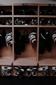 the inside of a hockey locker filled with lots of helmets and gloves on it's shelves