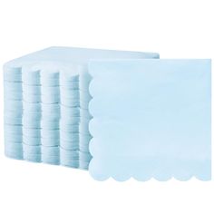 a stack of blue napkins with scalloped edges on each side and a white background