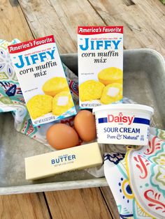 three boxes of jelly corn muffins and butter on a tray with an american's favorite brand