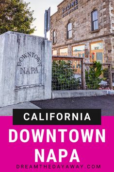 the sign for downtown napa in front of a building with pink and black lettering