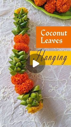 an arrangement of flowers arranged in the shape of a letter with words coconut leaves hanging