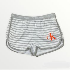 Brand New With Tags! Calvin Klein Child’s 6x Grey Striped Logo Shorts Stretchy Elastic Band Extremely Comfortable Stretchy Polyester Orange Ck Printed Logo Size 6x Can Be Used As Pj Bottoms Or Comfy Lounge Shorts #611 B2 Trendy Calvin Klein Summer Bottoms, Trendy White Cotton Pajama Shorts, White Stretch Bottoms For Playwear, Calvin Klein Spring Shorts, Casual Letter Print Playwear Shorts, White Shorts With Elastic Waistband For Playwear, White Elastic Waistband Shorts For Playwear, White Cotton Playwear Shorts, Sporty Calvin Klein Summer Shorts