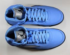 a pair of blue sneakers on a white surface