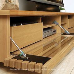 a wooden entertainment center with an electronic device in it