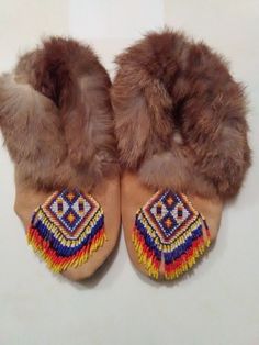 These Moccasins were handmade by me. They are size 5. They are fur lined.They have a beaded toe plug that is fringed on each toe. The leather is gold cow Suede. They were stitched together with sinew. Very strong stuff! This what the web of a dream catcher is made of. I made myself a pair of these moccasins  about 12 years ago and they are still in good shape and worn a lot. Traditional Brown Hand-stitched Moccasins, Traditional Brown Moccasins For Festival, Baby Moccasins, Pow Wow, American Leather, Native American Fashion, American Fashion, American Beauty, Rabbit Fur