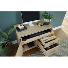 a computer desk with drawers underneath it