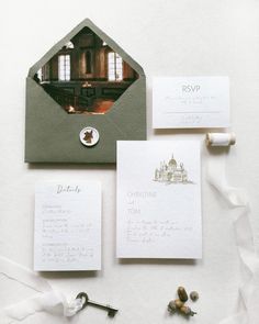 the wedding stationery is laid out on top of paper and some other things to include