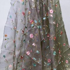 Grey Pure Silk Organza Embroidered Fabric by the yard Indian Embroidery Bridal Sheer Floral Wedding Dress Delicate Designer Dress Material Saree  ➤Material: 100% Pure Silk Organza ➤ Color: Powder Green, Pink, Blue, Brown Embroidery on Grey Organza Silk Fabric. ➤ Width: 44 Inches ➤ Code: sfe59 ➤ Listing for 1 yard of fabric.  This is a beautiful Organza Silk Fabric with delicate embroidery will add glamour to your special occasion. Gentle to touch and feels great on your skin. If you like working with natural fibers this fabric is for you. Will work very well for wedding dresses, gowns, crafty projects, hair accessories, veils, hats.  Wash & Care/Fabric Handling Instructions: ➤Do not wash ➤Iron at Medium Heat ➤No Steam Iron ➤Dry Clean only ➤Hang Under Shade If you purchase more than 1 yard Green Embroidered Dress With Dupatta For Wedding, Green Embroidered Dress For Wedding And Festivals, Embroidered Wedding Dress With Dupatta For Festivals, Chanderi Embroidered Fabric For Spring Wedding, Wedding Embroidered Dress With Dupatta, Wedding Embroidered Dress With Dupatta For Festivals, Chanderi Embroidered Fabric For Wedding In Spring, Green Embroidered Dress With Resham Embroidery For Wedding, Spring Bollywood Embroidered Lehenga