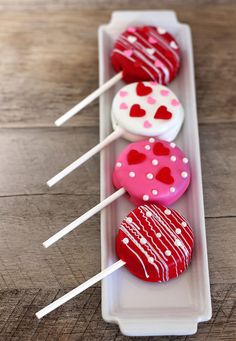 valentine's day desserts on sticks in a white tray