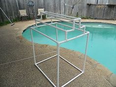 a pool with a metal frame around it and a chair next to it in the background