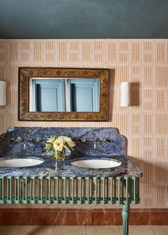 two white sinks sitting under a mirror in a bathroom next to a radiator