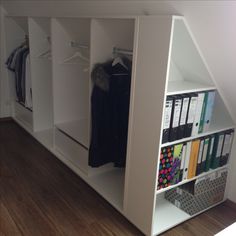 an organized closet with books, binders and folders on it's shelves