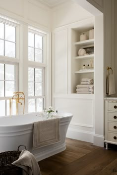 a white bath tub sitting next to a window