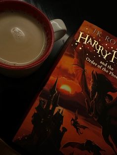 a harry potter book next to a cup of coffee