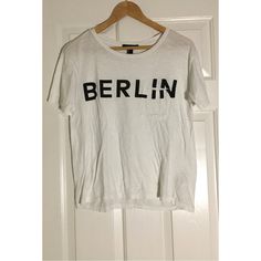 Forever21 White Short-Sleeve Graphic “Berlin” Tee Size Small. Never Worn. Like New. Excellent Condition. No Tags. No Flaws. Material: 100% Cotton Measurements (Taken While Laying Flat): Full Length: 23 3/4 In. Bust: 19 In. (Double) Waist: 18 In. (Double) Bottom Hem: 16 1/2 In. (Double) Arm Hole: 6 In. (Double) Sleeve Length: 6 5/8 In. Shoulder Width: 4 7/8 In. Tags: White Tee, Womens, Summer, Casual, Streetwear, Berlin, Winter, Fall, Christmas, Spring, Vacation, Graphic Tee, Short-Sleeve, Lounge Trendy Crew Neck Shirt For Day Out, Forever 21 Short Sleeve Tops With Letter Print, Forever 21 Letter Print T-shirt For Summer, Forever 21 Relaxed Fit Short Sleeve T-shirt, Forever 21 Relaxed Fit Short Sleeve Tops, Casual Short Sleeve T-shirt By Forever 21, Forever 21 Relaxed Fit Summer T-shirt, Forever 21 Relaxed Fit T-shirt For Summer, Forever 21 Short Sleeve Streetwear Tops