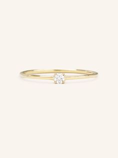 A luminous quintessential beauty. This petite four-prong ring features a sparkling diamond. It's set in a dainty ring that can be worn from day to night. 14k Gold Cluster Ring With Single Diamond, Dainty White Gold Diamond Ring With Vs Clarity, Delicate Diamond Ring Vs Clarity, Elegant Diamond Midi Rings Round Cut, Dainty Diamond Midi Rings With Round Cut, Delicate White Gold Diamond Ring With Vvs Clarity, Diamond Solitaire Midi Rings In Fine Jewelry, Delicate 14k Gold Stackable Rings Brilliant Cut, Delicate Diamond Birthstone Ring With Round Band