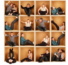 a group of people sitting on top of wooden boxes with their arms in the air