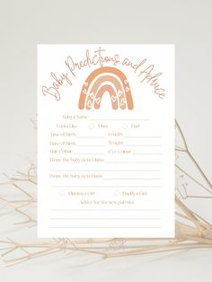 a card with an orange and white rainbow in the middle, on top of dry grass