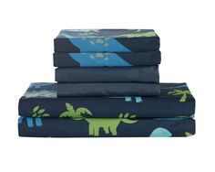 three sheets with dinosaurs on them are stacked up in front of each other and one is blue