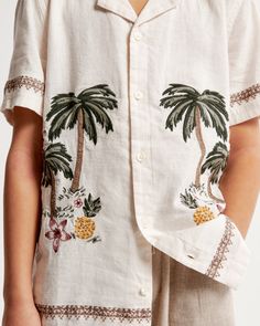 Comfortable short-sleeve shirt in a soft linen-blend fabric, with resort-style camp collar, embroidered graphic details at chest and button-up front. Beige Camp Shirt For Spring Vacation, Summer Vacation Beige Camp Shirt, White Linen Camp Shirt For Summer, Beige Relaxed Fit Camp Shirt For Beach, Relaxed Fit Beige Camp Shirt For Vacation, Beige Relaxed Fit Camp Shirt For The Beach, Beige Relaxed Fit Camp Shirt For Vacation, Beige Camp Shirt For Beach And Summer, Beige Cotton Camp Shirt For Summer