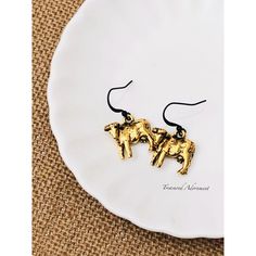 Cow earrings in antiqued gold tone. Length (from the earlobe): 1 3/8 inches (approx. 3.5 cm) Dimensions of the charm: 2 x 1.5 cm (approx 3/4 x 1/2 inch) Comes in a gift box, ready for gift giving. For domestic (U.S.) customers: Ships via USPS First Class mail with delivery confirmation after the payment has been received and the production is complete. You will receive a notice with the tracking number once the item ships. International customers: Your items will ship via US First Class mail, but will NOT come with the delivery confirmation number. You will receive the customs form number, which will give you some information about your shipment. If you would like your item to be shipped via priority, registered mail, or with insurance, which enables you to track your shipment, please conv Gold Drop Earrings With Antique Finish, Gold Metal Earrings With Antique Finish, Gold Antique Finish Metal Earrings, Gold Earrings With Antique Finish, Gold Earrings With Antique Finish For Gift, Farm Earrings, Bull Earrings, Miniature Earrings, Cow Jewelry