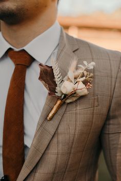 a man in a suit with a boutonniere on his lapel