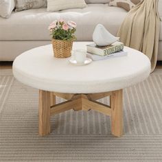 a living room with a white couch and coffee table