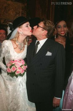 a man kissing a woman on the cheek at a wedding