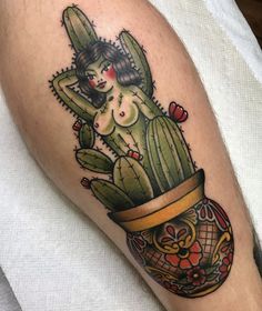 a woman is sitting on top of a cacti pot with flowers in it