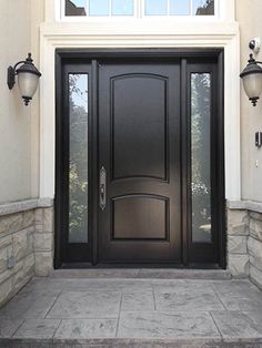 a black front door with two lamps on either side