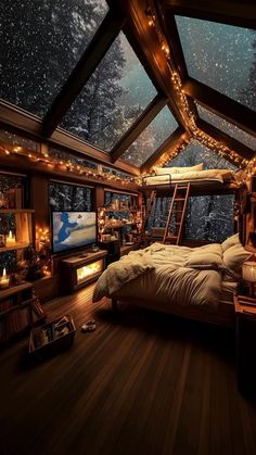 a bed sitting under a skylight in a bedroom next to a window filled with lights