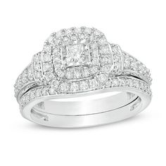 a white gold ring set with two rows of diamonds on the band and a square shaped diamond