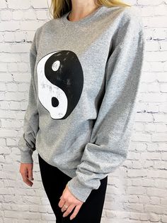 About -Oversized -50% Cotton 50% Polyester -Hand Wash -Crewneck Pullover -Distressed Ying Yang Graphic It's time to pull out your 90's nostalgia out of the back of the closet. We are in love with this oversized crew neck sweatshirt with a distressed ying-yang graphic at the front. We love this paired with a pair of bike shorts or leggings for a casual style for any day of the week. Oversized Crew Neck Sweatshirt, 90s Nostalgia, Ying Yang, Day Of The Week, The Closet, Bike Shorts, Casual Style, In Love, Crew Neck Sweatshirt