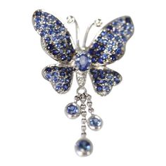 This is part of Chairish’s Fine Jewelry assortment.  Vintage circa 1960’s Sapphire butterfly brooch pendant 2 carats of sapphires  GORGEOUS BUTTERFLY BROOCH OR PENDANT CIRCA 1960 IS SET IN 18K WHITE GOLD. THIS GORGEOUS PIECE HAS A TASSEL OF SAPPHIRES DANGLING DOWN WITH MOVEMENT WHEN WALKING. THIS PIECE IS FRESH FROM AN AUCTION IN BERLIN AND IS IN EXCELLENT CONDITION. THERE ARE ABOUT 2 CARATS OF SAPPHIRES IN THIS BROOCH.  METAL: 18K WHITE GOLD WEIGHT: 6 GRAMS STONES: SAPPHIRES ROUND @ 2 CARATS SI Blue Sapphire Brooch For Gift, Blue Sapphire Brooches For Gift, Blue Sapphire Brooches As Gift, Luxury Butterfly Brooch As Gift, Luxury Butterfly Brooches For Gifts, Luxury Sapphire Brooches Gift, Luxury Sapphire Brooches As Gifts, Luxury Sapphire Brooches For Gift, Luxury Sapphire Brooches As A Gift