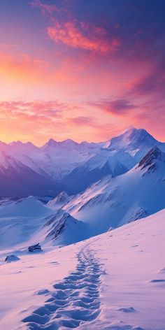 a trail in the snow with mountains in the background at sunset or sunrise, as seen from above