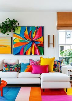 a living room with colorful rugs and paintings on the wall, furniture and decor