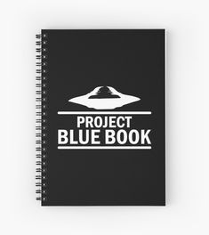 a spiral notebook with the words project blue book written in white on it and an image of