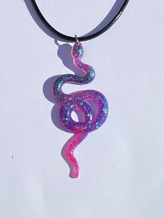 A beautiful handmade snake pendant. A great gift for a loved one or yourself! Each pendant is unique and one of a kind. This necklace is lightweight, durable. The black necklace cord is 45cm in length with a silver lobster claw clasp and 5cm extension chain, you can adjust the length to fit your needs. Other colours available in my store and more coming soon. If you have any request for any specific colour(s) or themes, feel free to contact me and I will see what I can do. :)  Custom orders avai Resin Pendants, Necklace Resin, Pink Snake, Snake Pendant, Necklace Cord, Snake Necklace, Painted Ornaments, Hand Painted Ornaments, Custom Hand Painted