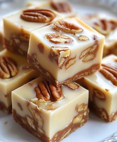 several pieces of white chocolate with pecans on top