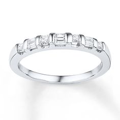 a white gold wedding band with baguetts on the side and diamonds in the middle